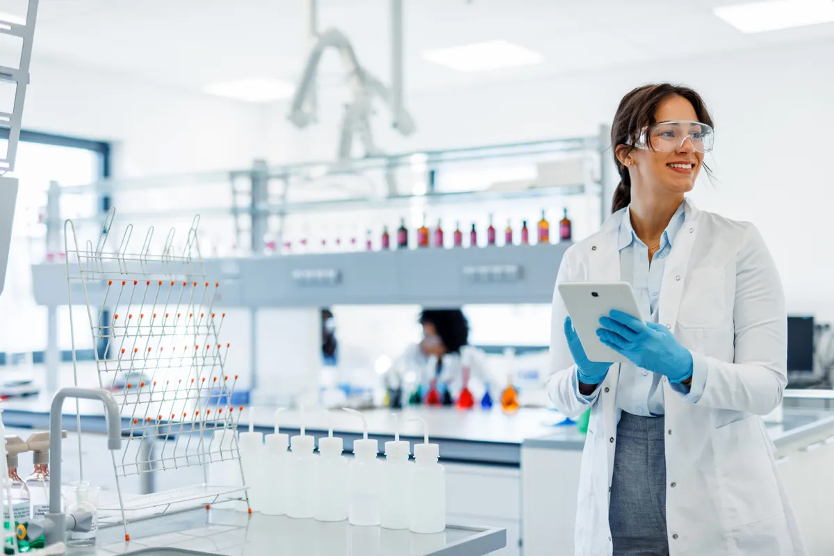 A technician holding a tablet in a laboratory