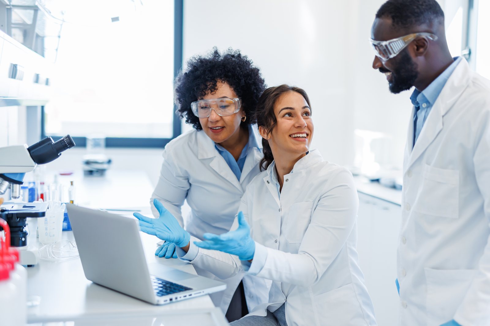Product stewards and scientists collaborating on compliance software in the lab